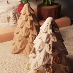 A close-up of our handmade Jesmonite Christmas trees. The one in front is finished with delicate gold leaf, adding a touch of sparkle, while the one behind showcases the simple, natural texture of the material.