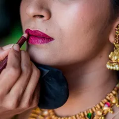 A close-up shot of the bride's makeup being applied. We love capturing these detailed, behind-the-scenes moments of the bridal preparation.