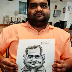 A guest holding his finished black and white caricature. The simplicity of the ink drawing puts all the focus on the exaggerated features and the subject's expression.
