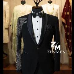 For the man who commands attention, this classic black tuxedo is elevated with striking silver hand embellishments on the sleeve and shoulder. It's a perfect example of modern luxury for a reception or black-tie event.