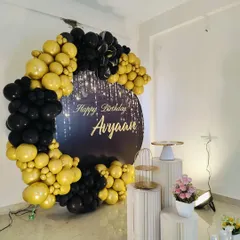 A side view of the black and gold setup, showing the arrangement of the cake stands.