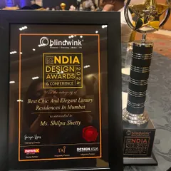 A close-up of the trophy and certificate for "Best Chic And Elegant Luxury Residences In Mumbai." Every award feels special and motivates us to keep pushing our creative boundaries.