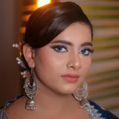 A close-up portrait showcasing the sharp, blue winged eyeliner. This is a great way to add a touch of color to a classic look.
