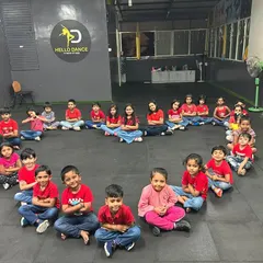 Our students sitting in a heart formation, smiling for the camera. This photo perfectly represents the love and friendship that blossoms in our dance classes.