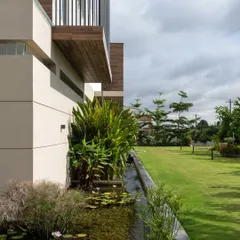 The Celadon residence, a quiet retreat nestled within a one-acre farm. Here, our design blur the line between architecture and landscape, with a tranquil koi pond and lush plantings that wrap around the home, integrating it seamlessly into its natural surroundings.