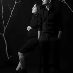 There is a special kind of magic in monochrome. This classic black and white maternity portrait focuses on emotion and connection, using dramatic lighting to create an elegant and artistic image of a couple awaiting their new arrival.