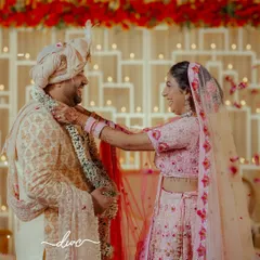 The joy and laughter during a Jaimala ceremony are perfectly captured in this candid shot, as the bride playfully places the garland on her groom.