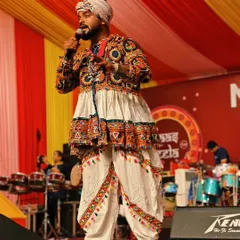 On stage at a Navratri event, singing and engaging with the crowd. My traditional Gujarati outfit is a tribute to the spirit of the festival.
