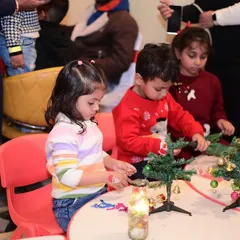 Little elves at work! Children participated in a Christmas craft session, decorating their own mini Christmas trees to take home.