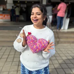 Here I am, overjoyed with one of my handmade crochet hearts! I make these little charms in all sorts of colors and sizes. They are perfect as personalized gifts, keychains, or just a small token to show someone you care.
