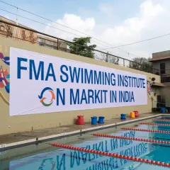 This banner at a competitive swimming pool announces our arrival in the Indian market. I am here to dominate the industry and set a new standard for aquatic services.