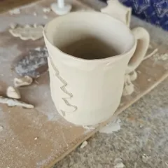 A hand-built mug in its beginning stages. Even simple forms can be personalized with unique textures and designs.