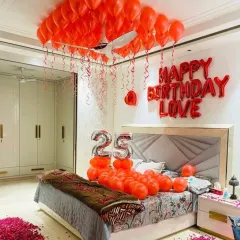 A full room view of the 25th birthday surprise, showing the decorated bed, rose petals on the floor, and balloons.