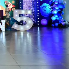 Light-up marquee numbers are a fantastic focal point for birthday photos. This large number '5' adds a professional and celebratory touch to the party decor.