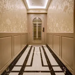 The foyer is the first impression of your home. This elegant entryway features beautiful monochrome inlay flooring, classic wall paneling, and a delicate floral wallpaper.