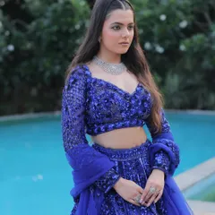 A confident pose in our electric blue designer lehenga. The rich color and intricate work make it a perfect choice for an engagement or a wedding guest look.
