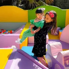 Big smiles and helping hands! Our play areas are great for siblings and friends to play together safely.