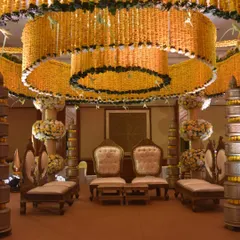 For this indoor wedding, we brought traditional grandeur to life with a magnificent mandap crafted from marigolds. The tiered canopy structure, built around the ballroom's chandelier, creates a warm, golden glow, perfect for sacred Hindu wedding rituals.