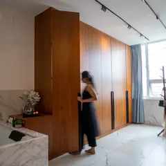 This view shows the impressive height of the custom wardrobes and a secret door panel that blends seamlessly into the design.