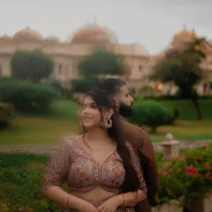 A soft, dreamy portrait with a creative blur effect, placing the focus on the bride's joyful expression during her Udaipur pre-wedding shoot. The palace backdrop adds a touch of fairytale magic.