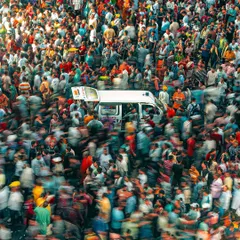 Another perspective of the massive crowd at the Rath Yatra, with an ambulance making its way through. It's a moment of organized chaos.