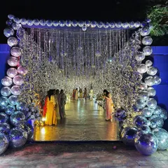 We make entrances that stop you in your tracks. This Sangeet night began with a walk through a tunnel of shimmering silver and disco balls, creating an immersive experience that instantly set a glamorous, party-ready vibe.