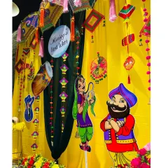 I love incorporating fun, cartoonish cutouts of a Punjabi couple to add a playful touch to the traditional Lohri decor.