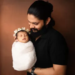 A father holding his whole world. This simple portrait focuses on that powerful, protective bond between a dad and his newborn.