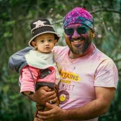 A happy portrait of a father and son duo during the Holi festival. The genuine smiles and relaxed hold show a comfortable and loving bond, which is what I aim to capture in my family photography.