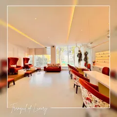 For the Fingertips Nail Studio, the goal was to create a space that feels both luxurious and tranquil. This wide view shows the pedicure and manicure stations, where I used a combination of plush, high-back red chairs and floral-patterned seating to add a pop of color and playful sophistication against a clean, white backdrop. The layout is open and airy, maximizing natural light to create a welcoming environment for clients.