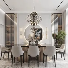 An elegant dining room setup featuring a statement chandelier over a modern oval table. The design is enhanced by a large circular mirror with backlighting, which adds depth and a warm glow to the room.