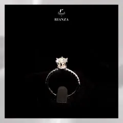 Another view of the solitaire ring with a hidden halo, showcasing the delicate diamond-studded band and the beautifully raised setting of the central stone.