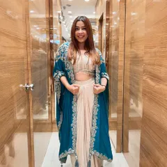 Don’t just stand out, stand in style. This stunning Indo-Western dhoti and cape set in teal and beige is the perfect example of modern ethnic fashion.