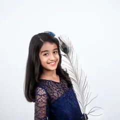 A simple and elegant studio portrait for kids. This shot focuses on her bright smile, using a clean white background to make her personality shine.