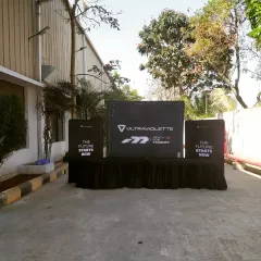 An outdoor branding and registration setup for the Ultraviolette launch. I create a cohesive brand experience from the moment guests arrive, with custom-printed counters and clear signage.
