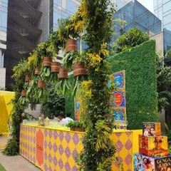 For a more playful and informal event, we can create fun, themed bars. This 'Theka' style bar uses quirky Bollywood posters, patterned designs, and a canopy of greenery to create a relaxed and engaging atmosphere.