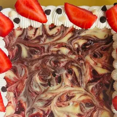 A close-up on the beautiful marbled swirl of strawberry and cheesecake within the rich brownie slab. It's a work of art you can eat.