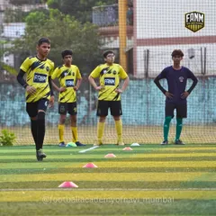 A group of players listening to instructions during a drill. This image captures the focus and unity of the team.