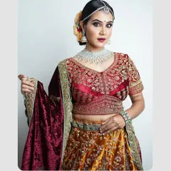 This full-length portrait highlights the beautiful details of a traditional lehenga. The studio lighting is set up to showcase the outfit's texture and color, making it a great shot for a model's portfolio or a clothing brand collaboration.