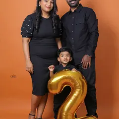 Celebrating a second birthday in style. This studio family portrait uses a bold, solid-color backdrop and a simple prop to mark a special milestone, creating a clean and classic image perfect for your wall.