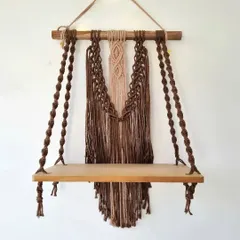 This intricately woven macrame shelf adds a touch of bohemian charm to any room. It's perfect for displaying your favorite small plants, books, or treasures.