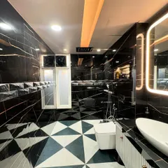 A glimpse into a luxury bathroom I designed, featuring black marble with gold veining and geometric floor tiles. I focus on high-end materials and flawless execution to create spaces like this, handling all the plumbing, tiling, and electrical work myself.