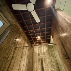 High ceilings can make even a smaller space like a bathroom feel grand and airy. Here, I used a wooden grid on the ceiling to add warmth and architectural interest, while also allowing for integrated lighting.