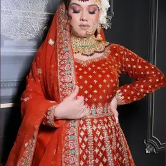 A full-length view of my red-orange velvet bridal outfit. The Anarkali-style silhouette is classic and flattering, while the detailed embroidery on the borders and waist belt adds a layer of handcrafted luxury.