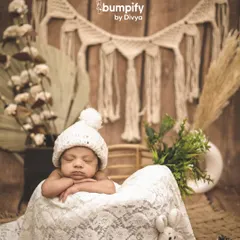 For this boho-themed newborn shoot, I used a rustic basket, lace, and macrame hangings to create a warm, earthy, and serene setting for the sleeping baby.