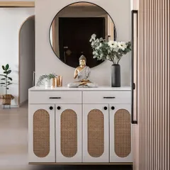 A closer look at this Japandi-style entryway console. The cabinet features woven rattan details, and the Buddha statue and plants create a calm, welcoming vibe.