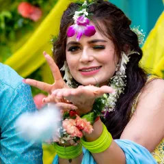 A playful bride winks and blows a kiss to the camera during her haldi function. These are the fun, candid moments I love to capture.