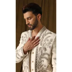 Another close-up of the 'Pragyran' shrug, focusing on the texture of the embroidery. You can see the different stitching techniques used to create depth and dimension in the floral patterns.