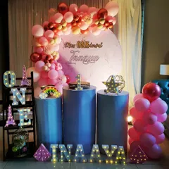 A chic and simple first birthday setup for Inaaya. The pink and rose gold balloon arch against a marble-print backdrop creates a modern and stylish look.