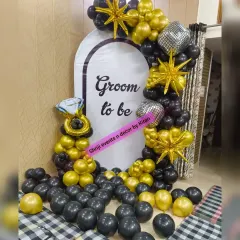 A stylish 'Groom to be' backdrop for a bachelor party or pre-wedding function. The black and gold balloon decor, with star and disco ball foils, creates a celebratory and modern look.